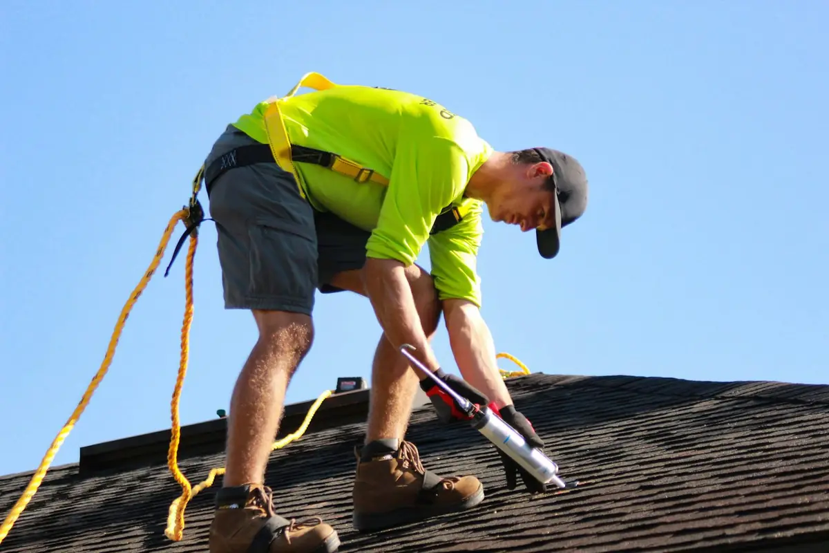 Roofer working on a shingle roof